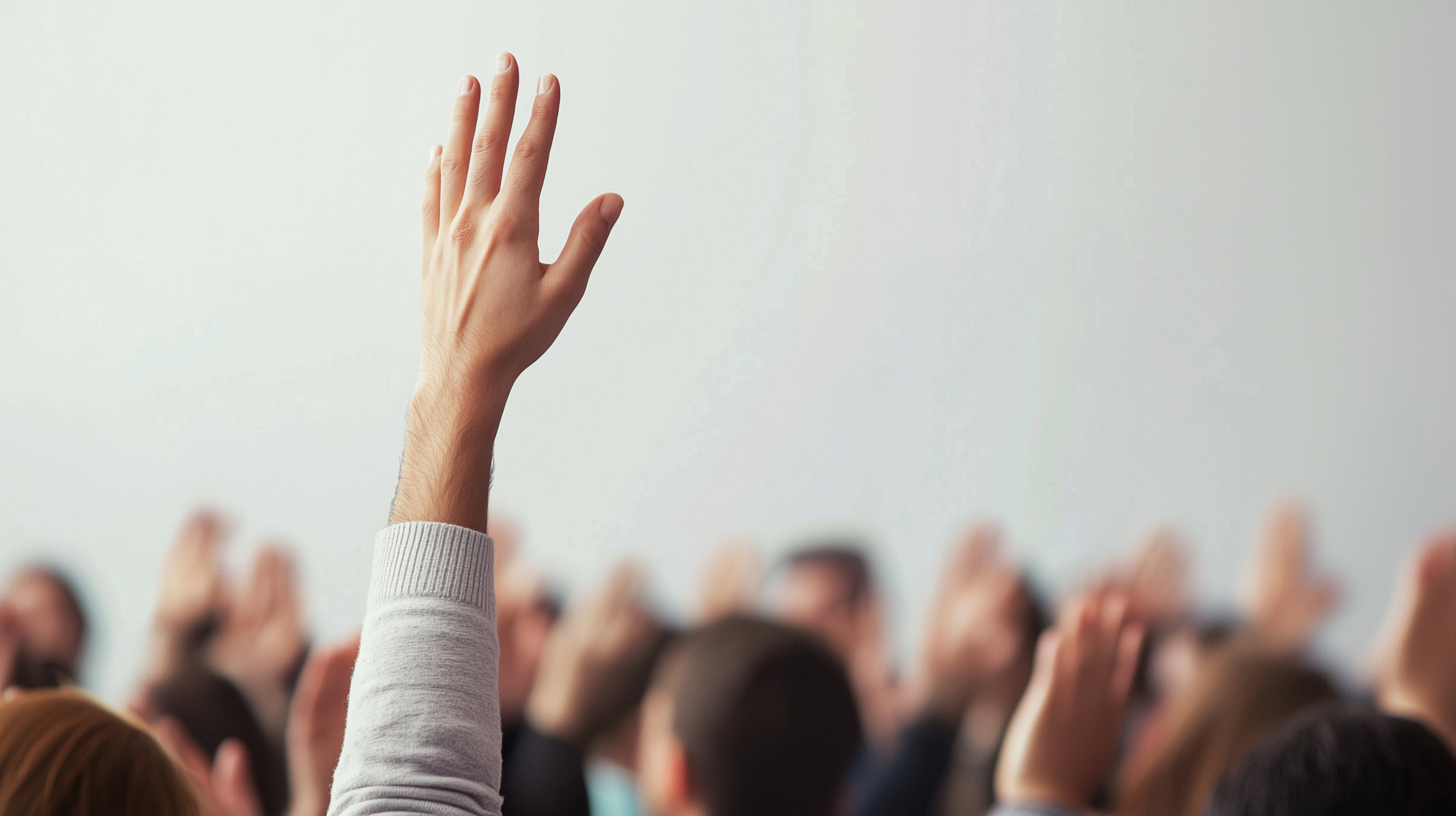 hands-raised-in-training-room