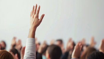 hands-raised-in-training-room