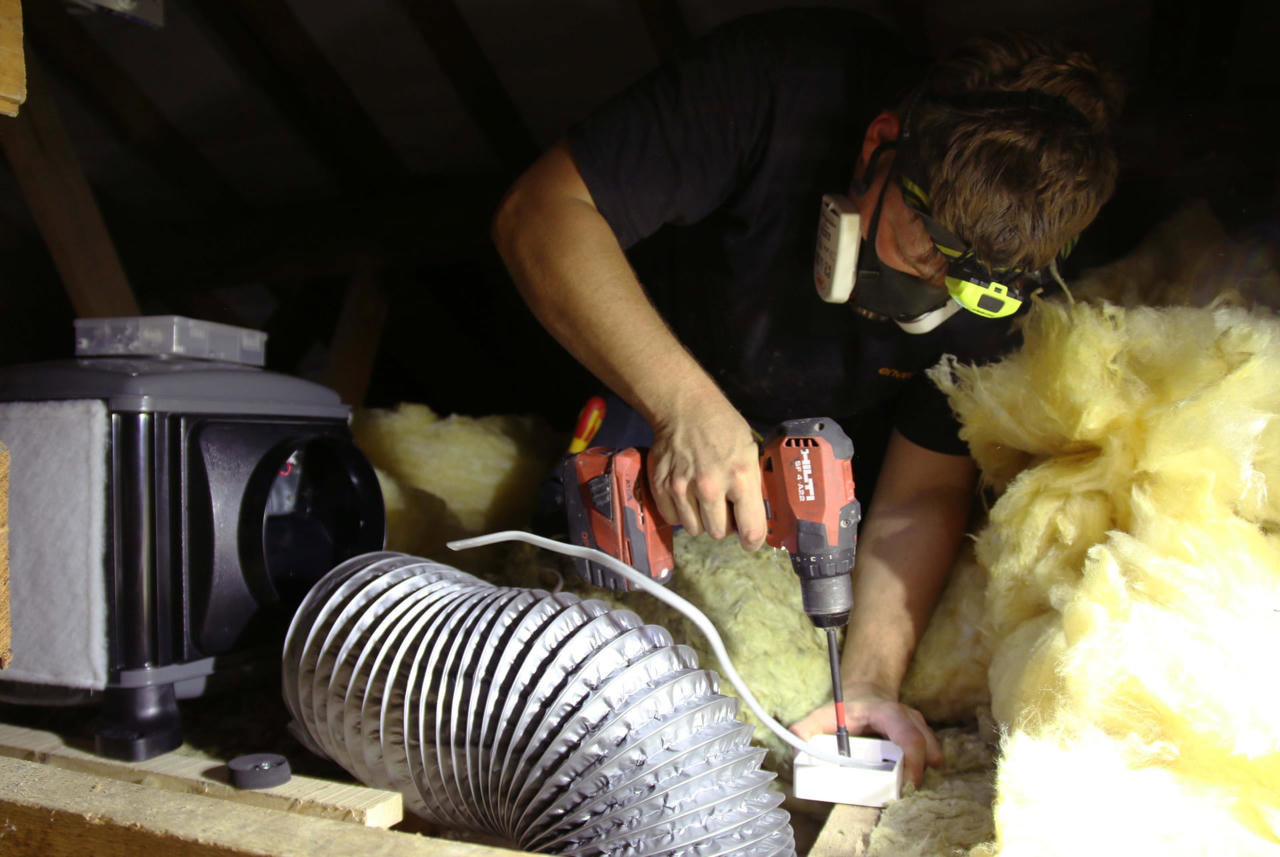 man-installing-positive-input-ventilation
