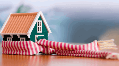A toy house with a scarf around it